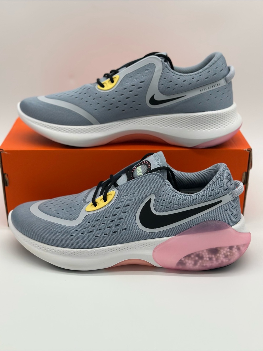 Nike Light Gray Running Sneakers with Black Swoosh and Pink & Yellow Accents